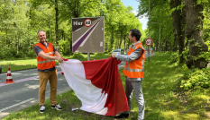 Gedeputeerde Arne Schaddelee van de provincie Utrecht trekt een doek af van een nieuw geplaatst 60 kilometerbord langs de N225 in Rhenen